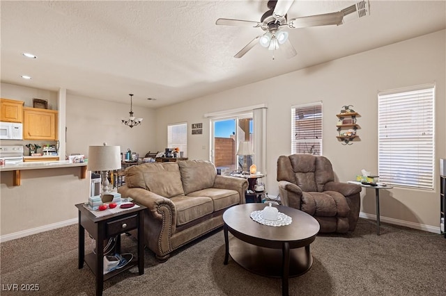 living room with recessed lighting, baseboards, dark colored carpet, and ceiling fan with notable chandelier