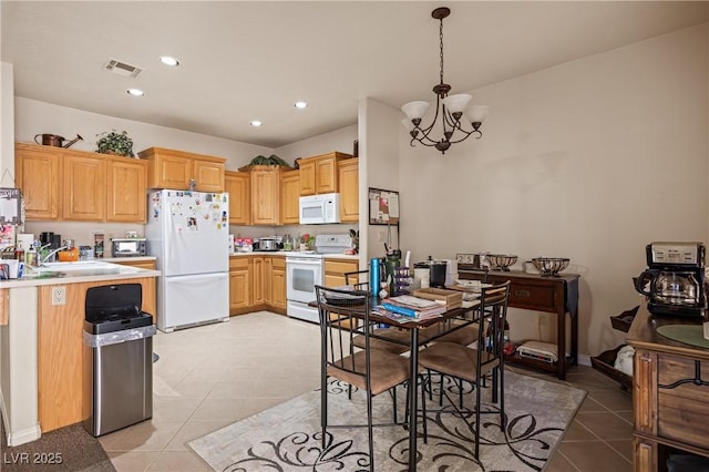 kitchen featuring light tile patterned floors, white appliances, visible vents, light countertops, and decorative light fixtures