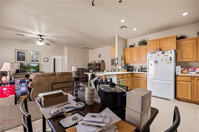 kitchen featuring light countertops, white appliances, visible vents, and open floor plan