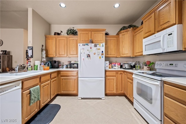 kitchen featuring light tile patterned floors, recessed lighting, light countertops, a sink, and white appliances