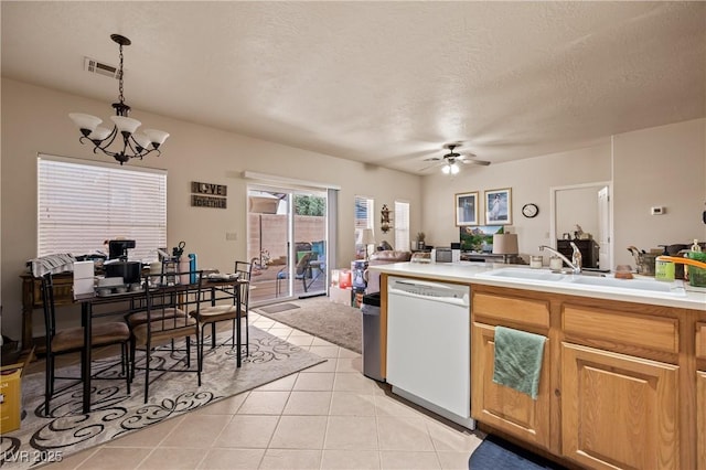 kitchen with a sink, visible vents, light countertops, dishwasher, and pendant lighting