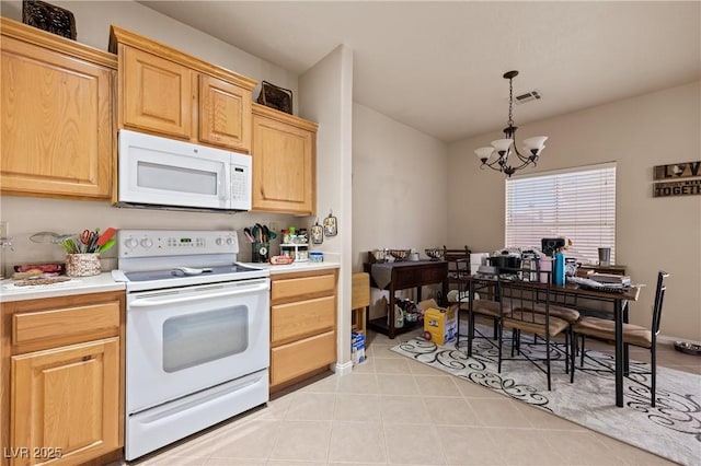 kitchen with white appliances, light countertops, hanging light fixtures, and visible vents