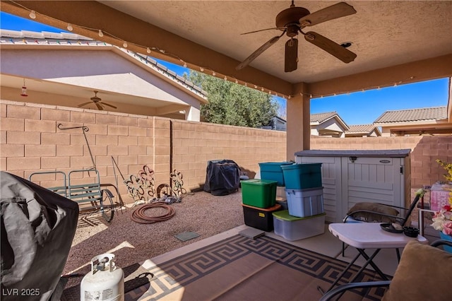 view of patio featuring ceiling fan and a fenced backyard