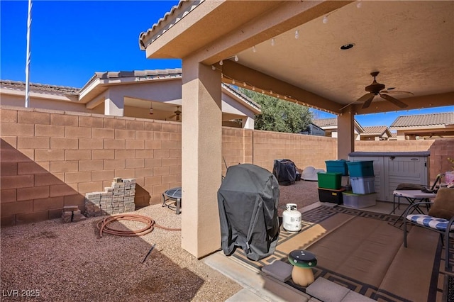 view of patio with a fenced backyard, a ceiling fan, and area for grilling