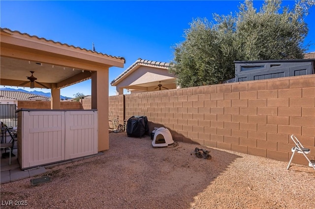 view of yard with ceiling fan, a patio area, and a fenced backyard