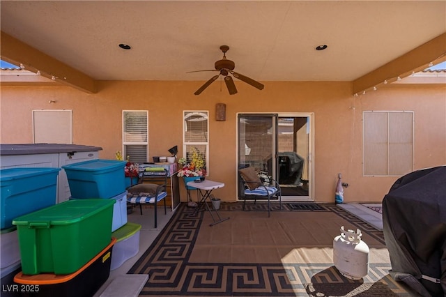 view of patio / terrace with ceiling fan, a hot tub, and area for grilling