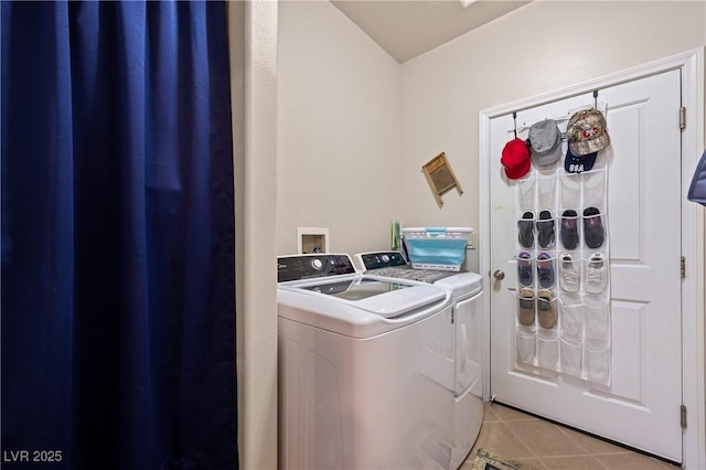 washroom with laundry area, light tile patterned floors, and washing machine and clothes dryer