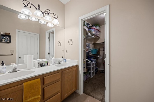 full bathroom with double vanity, tile patterned flooring, a closet, and a sink