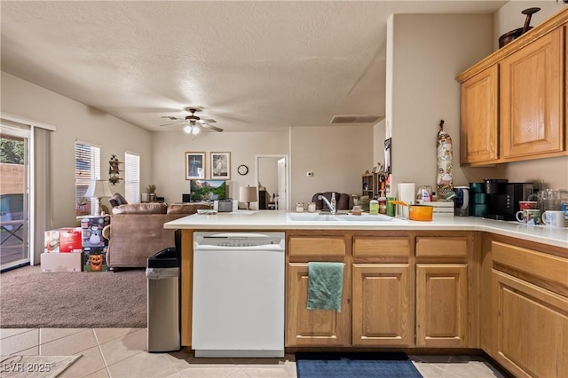 kitchen featuring open floor plan, white dishwasher, light countertops, a sink, and light tile patterned flooring