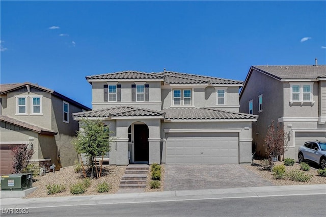 view of front of property featuring a garage, a tile roof, cooling unit, decorative driveway, and stucco siding