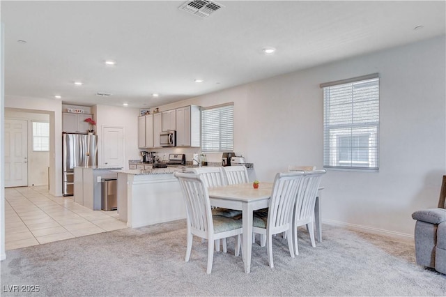 dining area featuring light carpet, light tile patterned floors, visible vents, and recessed lighting