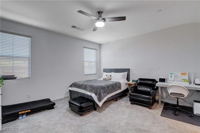 bedroom featuring baseboards, ceiling fan, visible vents, and light colored carpet