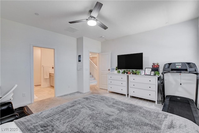 bedroom featuring light carpet, ensuite bath, ceiling fan, and visible vents