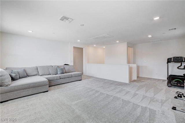 living room featuring recessed lighting, visible vents, and light carpet