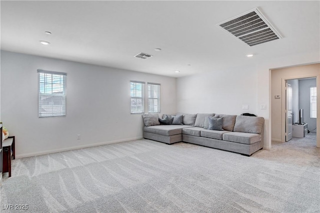 living area featuring light carpet, recessed lighting, visible vents, and baseboards