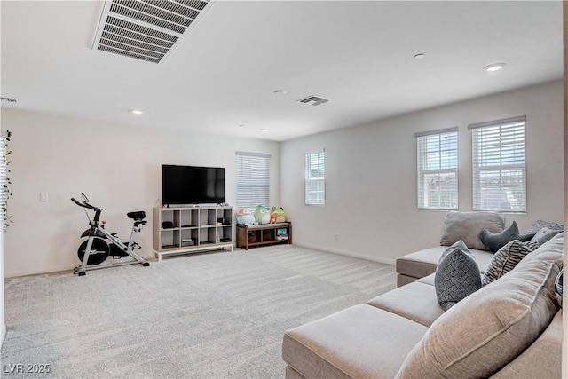 living area with light carpet, baseboards, visible vents, and recessed lighting