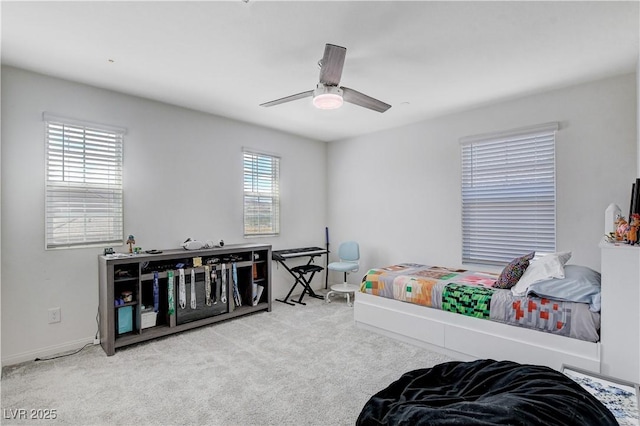 bedroom featuring a ceiling fan and light carpet