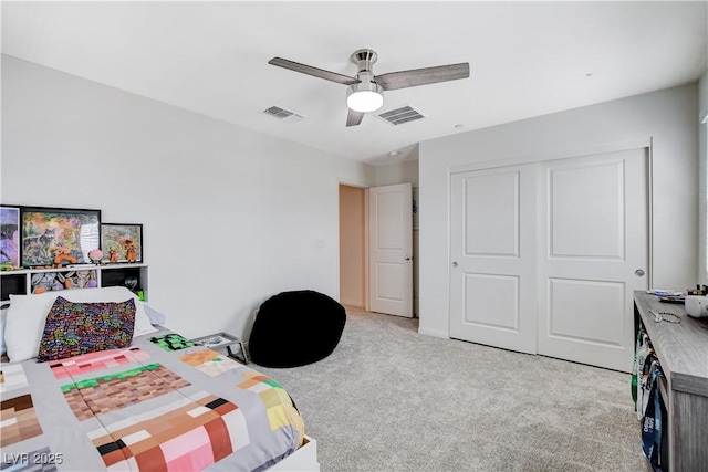 bedroom featuring light carpet, ceiling fan, a closet, and visible vents