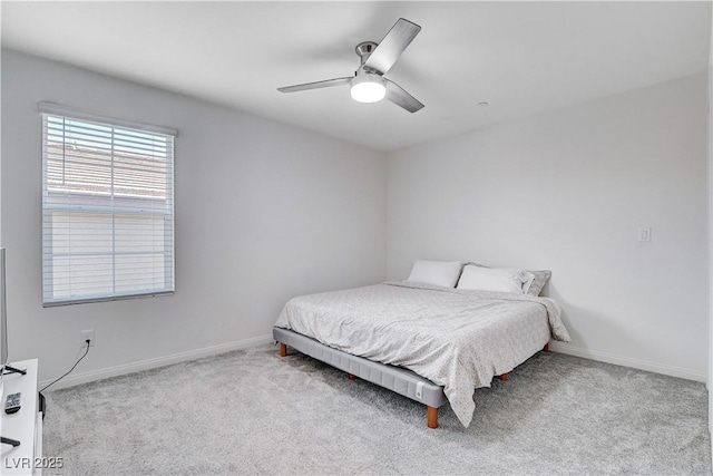 bedroom featuring a ceiling fan, light carpet, and baseboards