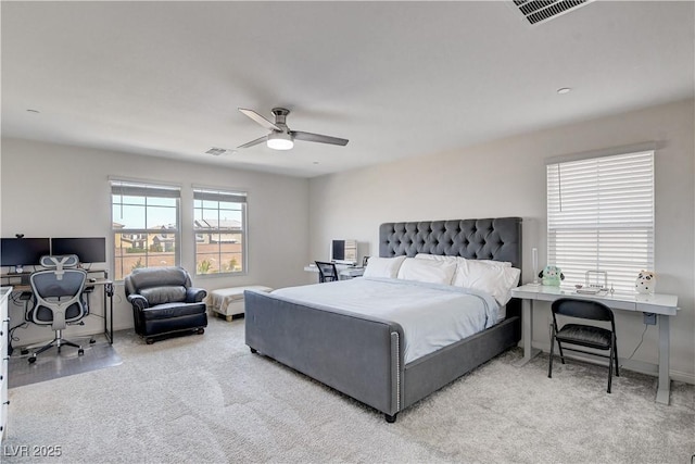 bedroom featuring light carpet, baseboards, visible vents, and a ceiling fan