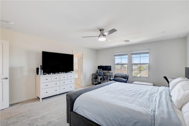 bedroom with light colored carpet, visible vents, a ceiling fan, connected bathroom, and baseboards