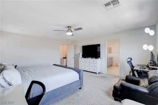 bedroom with light carpet, connected bathroom, visible vents, and a ceiling fan