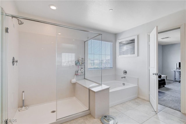 bathroom with a stall shower, tile patterned flooring, a garden tub, and visible vents