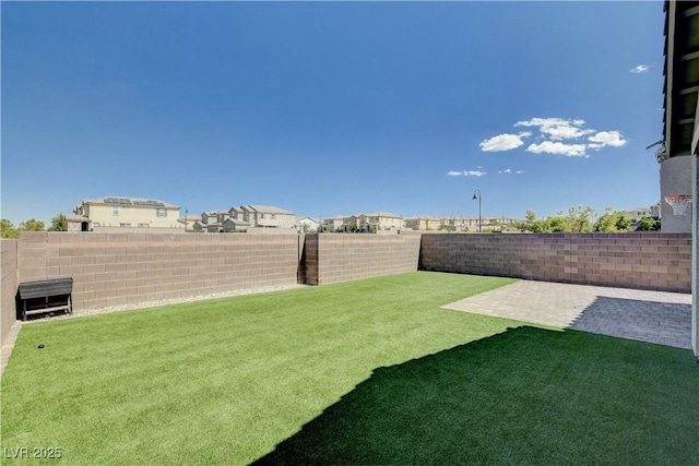 view of yard with a patio area and a fenced backyard