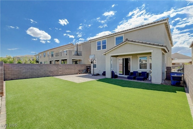 rear view of house featuring a patio area, a lawn, a fenced backyard, and stucco siding