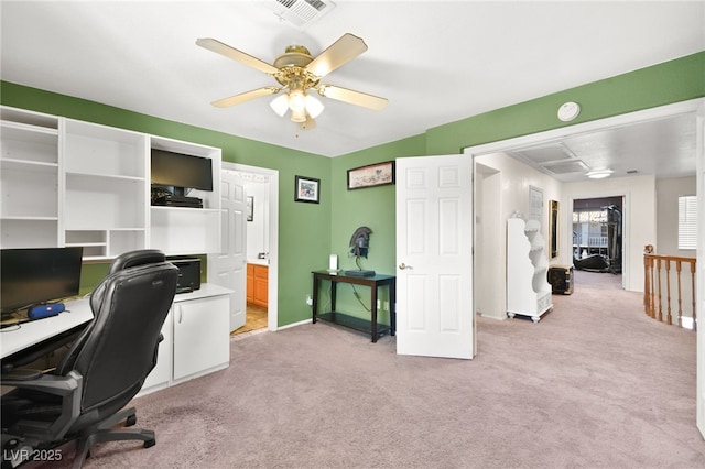 office space with ceiling fan, baseboards, visible vents, and light colored carpet