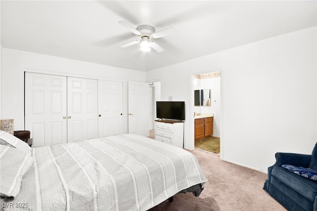 bedroom with a closet, ensuite bathroom, light carpet, ceiling fan, and baseboards