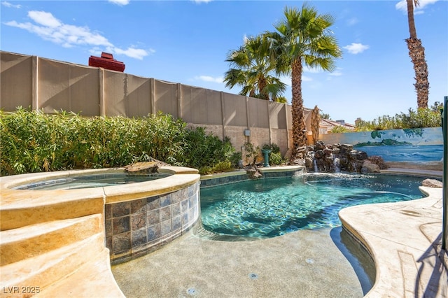 view of pool with a fenced backyard and a pool with connected hot tub