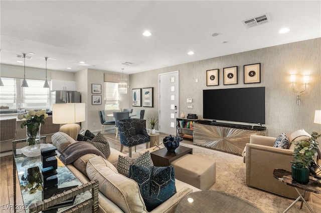 living area featuring baseboards, recessed lighting, visible vents, and wallpapered walls