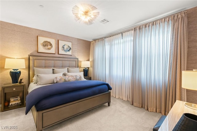 bedroom featuring light carpet, wallpapered walls, and visible vents