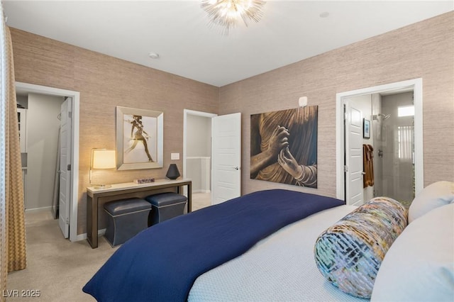 bedroom featuring ensuite bath, baseboards, and light colored carpet