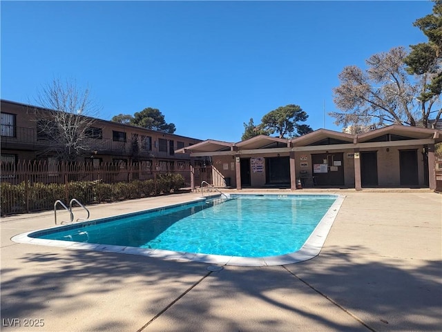 community pool featuring a patio and fence