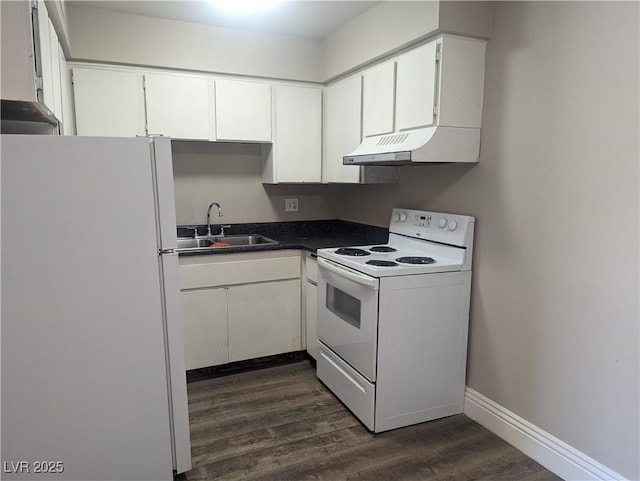 kitchen featuring white appliances, dark countertops, under cabinet range hood, white cabinetry, and a sink