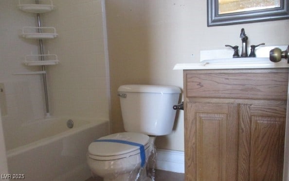 bathroom with toilet, vanity, and shower / bathtub combination