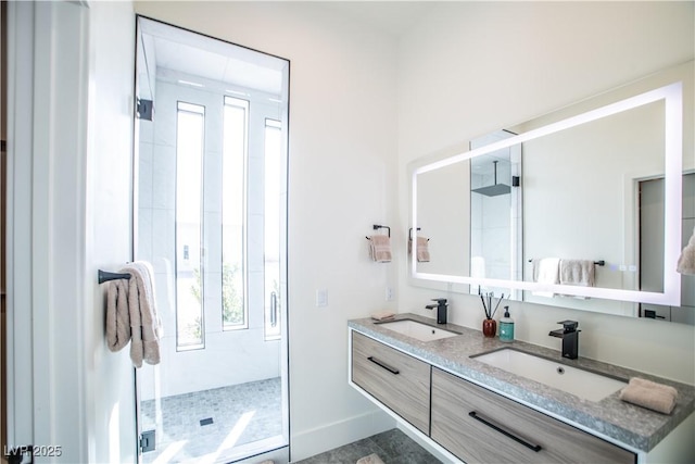 full bath featuring double vanity, a sink, and a healthy amount of sunlight