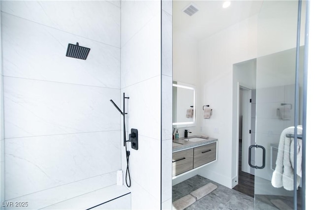 full bathroom featuring walk in shower and vanity