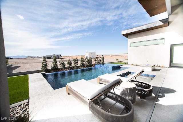 view of swimming pool featuring an infinity pool and a patio area