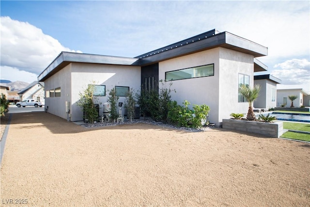 exterior space with driveway and stucco siding