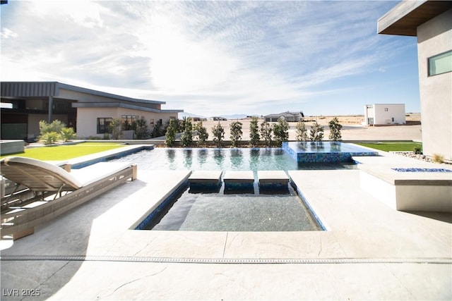 view of swimming pool with a pool with connected hot tub and a patio