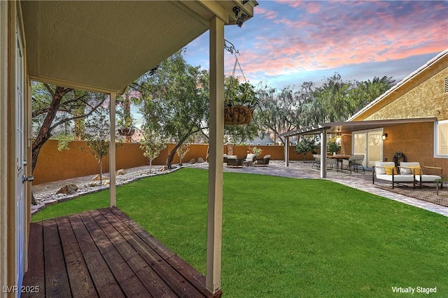 view of yard featuring outdoor lounge area, a fenced backyard, and a wooden deck