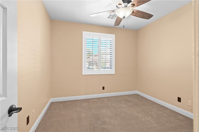 spare room featuring visible vents, carpet floors, baseboards, and a ceiling fan