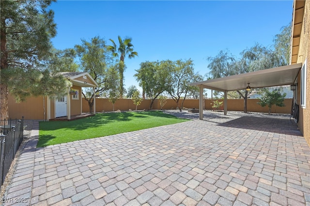 view of patio with an outbuilding and a fenced backyard