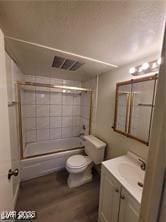 bathroom featuring bath / shower combo with glass door, visible vents, toilet, vanity, and wood finished floors