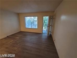 spare room featuring dark wood finished floors