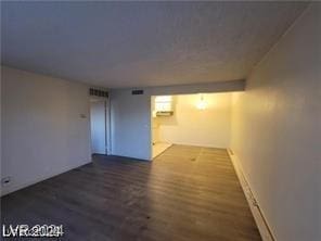 spare room featuring dark wood-type flooring