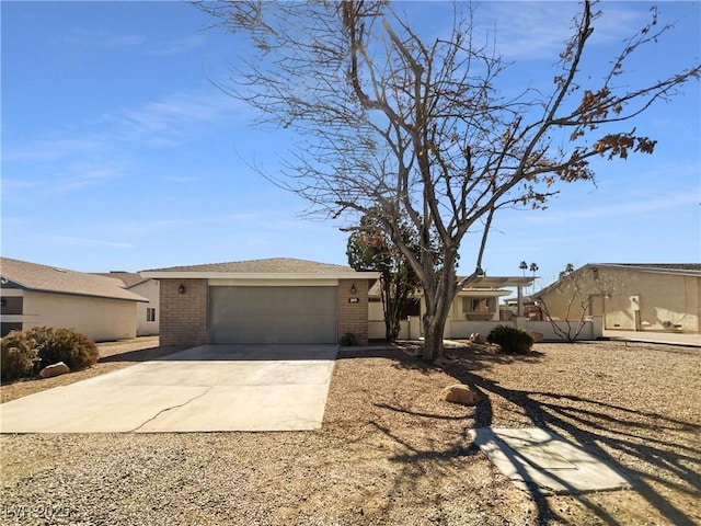 view of front of house with concrete driveway, brick siding, and an attached garage